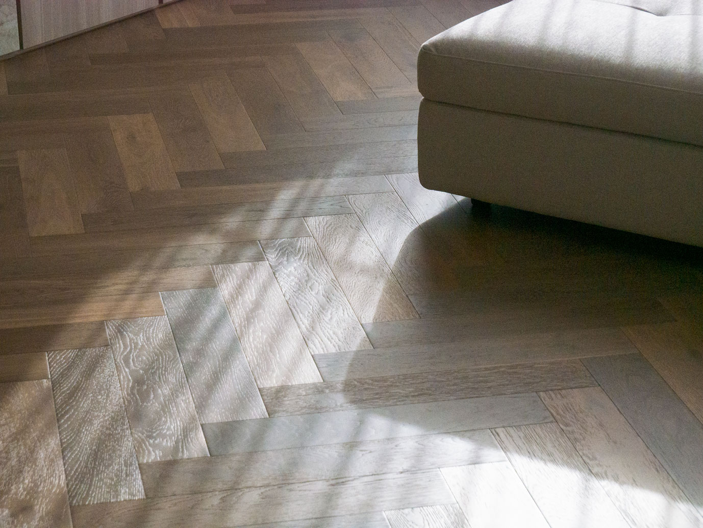 Herringbone timber flooring catching natural light at Clara Residence