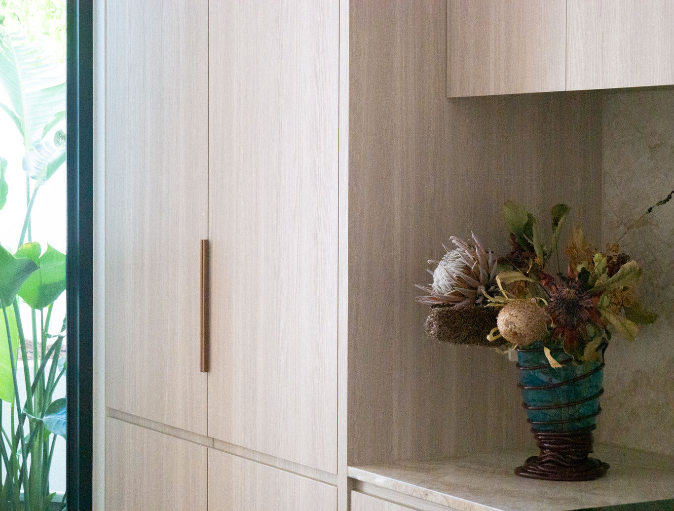 Vertical timber joinery detail with copper handle at Clara Residence