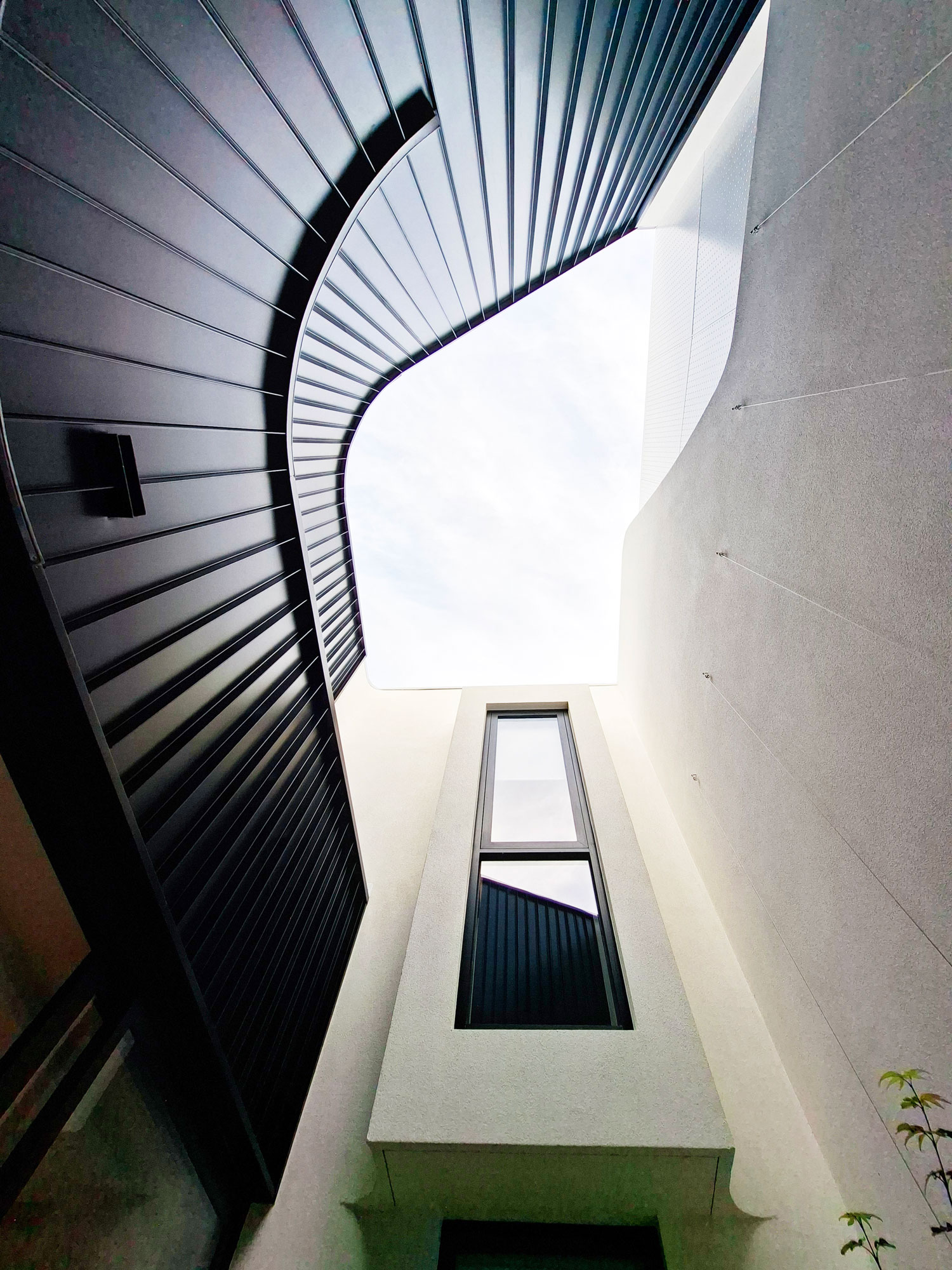 58 Clara Street South Yarra by Mike and Morlly Architects — facade looking up at perforated metal screen 58 Clara Street South Yarra by Mike and Morlly Architects — facade looking up at perforated metal screen