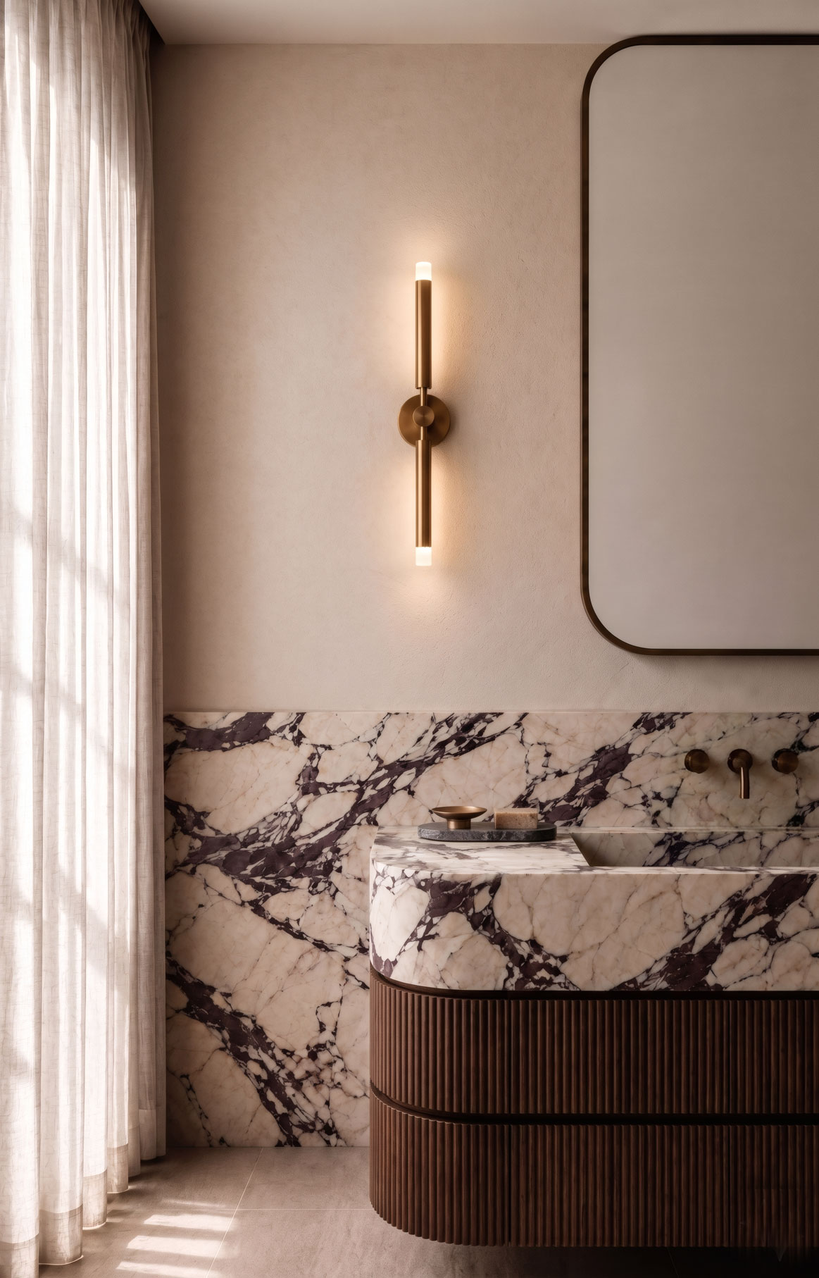 Stone vanity with curved timber drawers and alabaster wall sconce