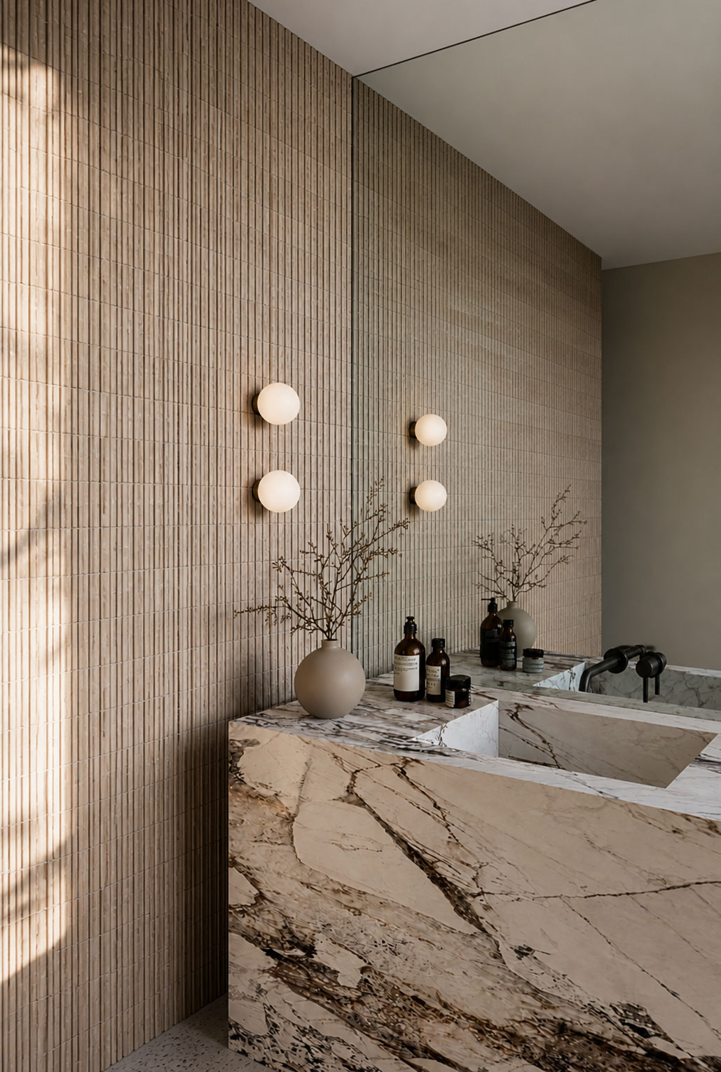 Veined marble vanity with fluted timber wall and globe sconces